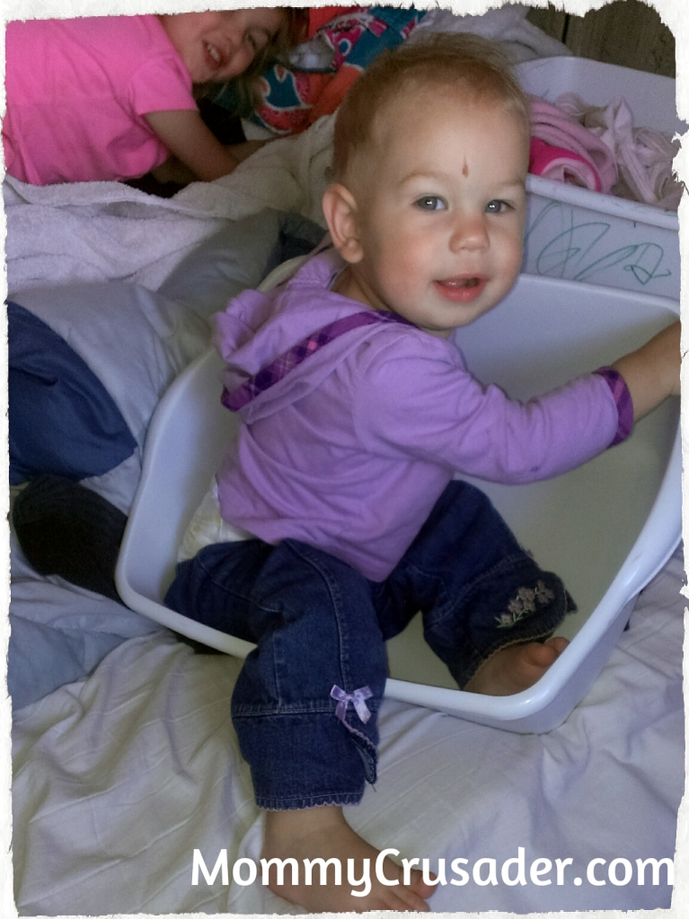 Hiding in the laundry bins | MommyCrusader.com
