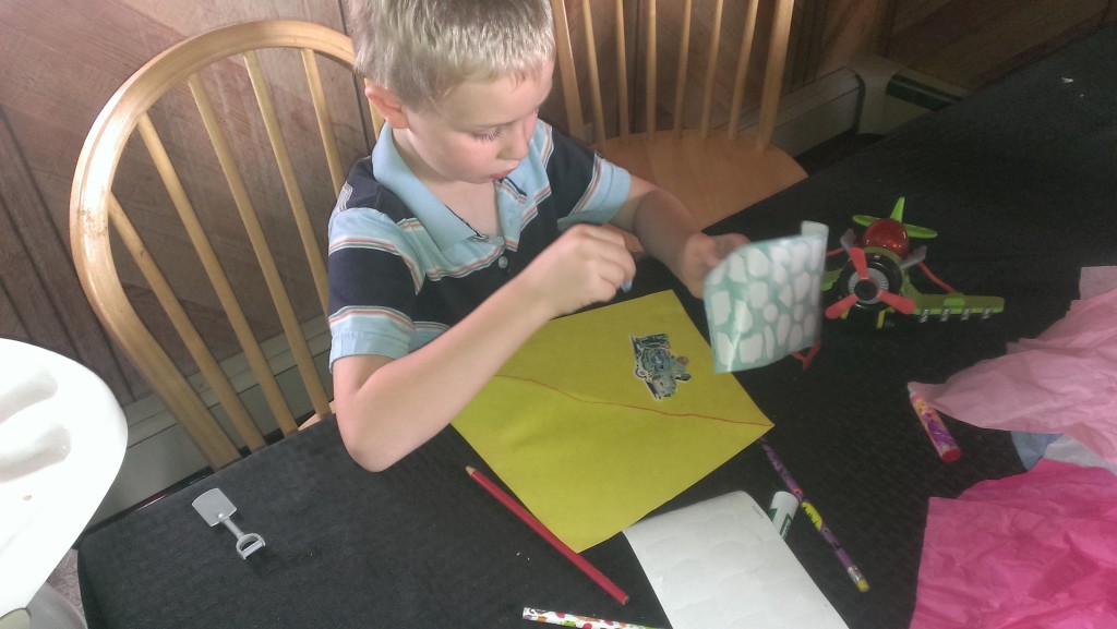 Kindergartner working on project at table. | mommycrusader.com